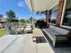 Covered porch with brick, outdoor seating, and a built-in grill overlooking the yard at 7079 S Locust Pl, Centennial, CO 80112