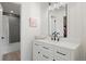 Modern bathroom with white vanity, matte black fixtures, and a shower with gray tiled walls at 7079 S Locust Pl, Centennial, CO 80112