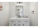 Clean bathroom with white vanity, matte black fixtures, and shiplap accent wall with modern mirror at 7079 S Locust Pl, Centennial, CO 80112