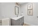 Stylish powder room featuring modern vanity, framed mirror, and neutral wall art at 7079 S Locust Pl, Centennial, CO 80112