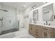 Bright bathroom with double vanity, tile floors, and a glass enclosed shower at 7079 S Locust Pl, Centennial, CO 80112