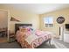 Bright bedroom featuring a patterned duvet cover, plush pillows, and natural light from the window at 7079 S Locust Pl, Centennial, CO 80112