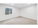 Bright basement bedroom with a window and neutral carpet at 7079 S Locust Pl, Centennial, CO 80112