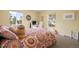 Comfortable bedroom with a patterned comforter, a desk, and plenty of natural light at 7079 S Locust Pl, Centennial, CO 80112