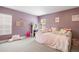 Comfortable bedroom featuring soft lighting, playful decor, and a cozy daybed with plush pillows at 7079 S Locust Pl, Centennial, CO 80112