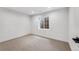 Bright basement bedroom with a window and neutral carpet at 7079 S Locust Pl, Centennial, CO 80112