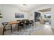 Elegant dining room features a long wooden table and modern chandelier at 7079 S Locust Pl, Centennial, CO 80112