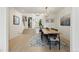 Open concept dining area with long wood table and chandelier at 7079 S Locust Pl, Centennial, CO 80112
