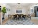 Bright dining room with a large wooden table and modern lighting at 7079 S Locust Pl, Centennial, CO 80112