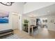 Open concept dining area with wood table, modern lighting, and view to living room at 7079 S Locust Pl, Centennial, CO 80112