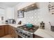 Gourmet kitchen with stainless steel appliances, custom cabinetry, and designer backsplash at 7079 S Locust Pl, Centennial, CO 80112