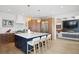 Modern kitchen with blue island, quartz countertops, stainless steel appliances, and pendant lighting at 7079 S Locust Pl, Centennial, CO 80112