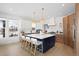 Spacious kitchen featuring a large island, modern appliances, and an abundance of natural light at 7079 S Locust Pl, Centennial, CO 80112