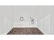 Laundry room with dark hexagon tiles and white walls at 7079 S Locust Pl, Centennial, CO 80112