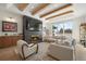 Bright living room with a stone fireplace, hardwood floors, and large windows at 7079 S Locust Pl, Centennial, CO 80112