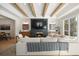 Cozy living room with fireplace, wood beams, and large windows providing ample natural light at 7079 S Locust Pl, Centennial, CO 80112