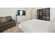 Spacious main bedroom offering a relaxing sitting area, TV, and ample storage space at 7079 S Locust Pl, Centennial, CO 80112