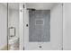 Modern glass shower featuring mosaic tile, white subway tile, and a niche for toiletries at 7079 S Locust Pl, Centennial, CO 80112