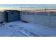 Private backyard with a storage shed and snow covered ground at 21459 Randolph Pl, Denver, CO 80249