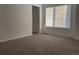 Carpeted bedroom with a window and door at 21459 Randolph Pl, Denver, CO 80249