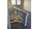 Upstairs landing with carpeted floors and a glass-paneled railing at 21459 Randolph Pl, Denver, CO 80249