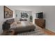 Inviting bedroom featuring a cozy bed, a large window, and modern furnishings at 6930 E Girard Ave # 106, Denver, CO 80224