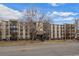 An attractive apartment building features multiple levels of units and well-maintained landscaping at 6930 E Girard Ave # 106, Denver, CO 80224