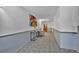 Well-lit hallway with carpet flooring, neutral paint, and decorative artwork at 6930 E Girard Ave # 106, Denver, CO 80224
