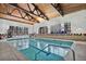 Bright indoor pool featuring a wood ceiling, tile accents, and large windows providing ample natural light at 6930 E Girard Ave # 106, Denver, CO 80224