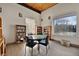 Library with bookshelves, a round table, and a large window offering natural light for reading and relaxation at 6930 E Girard Ave # 106, Denver, CO 80224