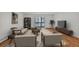 Bright living room features hardwood floors, a sliding door to the balcony, and stylish furnishings at 6930 E Girard Ave # 106, Denver, CO 80224