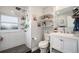 Bright bathroom featuring a tiled shower, white vanity, and modern fixtures at 4827 Meade St, Denver, CO 80221