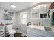 Modern bathroom with a white vanity, sleek fixtures, and humorous decor at 4827 Meade St, Denver, CO 80221