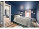 Stylish bedroom features a comfy bed, hardwood floors, and access to the backyard through a vibrant door at 4827 Meade St, Denver, CO 80221
