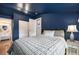 Cozy bedroom with striking navy blue walls, double closets, and an ensuite bathroom at 4827 Meade St, Denver, CO 80221