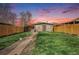 Charming home with a well-maintained front yard, walkway, and delightful sunset backdrop at 4827 Meade St, Denver, CO 80221