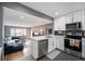 Open-concept kitchen with white cabinetry, stainless steel appliances, and modern finishes at 4827 Meade St, Denver, CO 80221