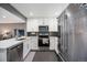 Well-equipped kitchen with stainless steel appliances, sleek countertops, and modern lighting at 4827 Meade St, Denver, CO 80221