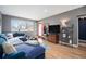 Bright living room with a cozy sofa, wooden floors, and vibrant natural light at 4827 Meade St, Denver, CO 80221