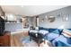 Cozy living room with a comfortable blue sectional couch and stylish decor at 4827 Meade St, Denver, CO 80221