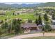 Charming home with a spacious yard surrounded by lush greenery and mountain views at 24030 San Isabel Rd, Indian Hills, CO 80454