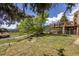 Sprawling backyard provides lush greenery and beautiful views with deck access at 24030 San Isabel Rd, Indian Hills, CO 80454