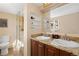 Bright bathroom features a double sink vanity, granite countertop, and walk-in shower at 24030 San Isabel Rd, Indian Hills, CO 80454