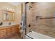 Bathroom with wood-look tile shower, modern fixtures, and marble countertop at 24030 San Isabel Rd, Indian Hills, CO 80454