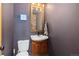 Cozy bathroom features a wood-trimmed mirror and stylish fixtures in a compact space at 24030 San Isabel Rd, Indian Hills, CO 80454