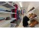Organized walk-in closet with shelving for ample storage of clothes and shoes at 24030 San Isabel Rd, Indian Hills, CO 80454