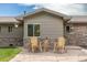 Inviting front patio with stone pavers and wooden chairs, creating a cozy outdoor seating area at 24030 San Isabel Rd, Indian Hills, CO 80454