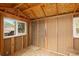 Unfinished interior showing wood frame walls, wood floors and a bright window with a view at 24030 San Isabel Rd, Indian Hills, CO 80454