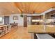 Bright and spacious kitchen with wood floors, granite countertops, wood ceiling, and stainless steel appliances at 24030 San Isabel Rd, Indian Hills, CO 80454
