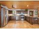 Well-equipped kitchen with wooden cabinets, stainless steel appliances, and a tiled floor at 24030 San Isabel Rd, Indian Hills, CO 80454